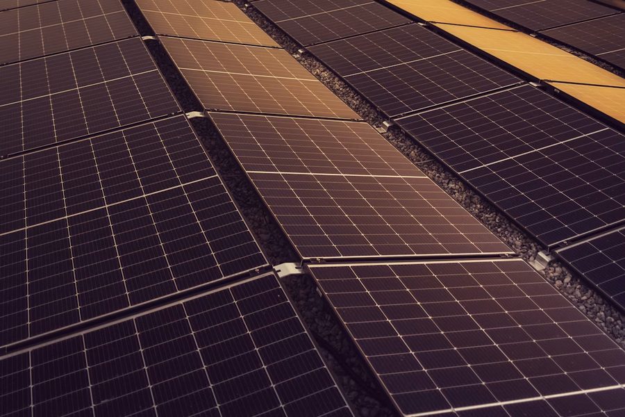 Rows of solar panels installed on a commercial building roof